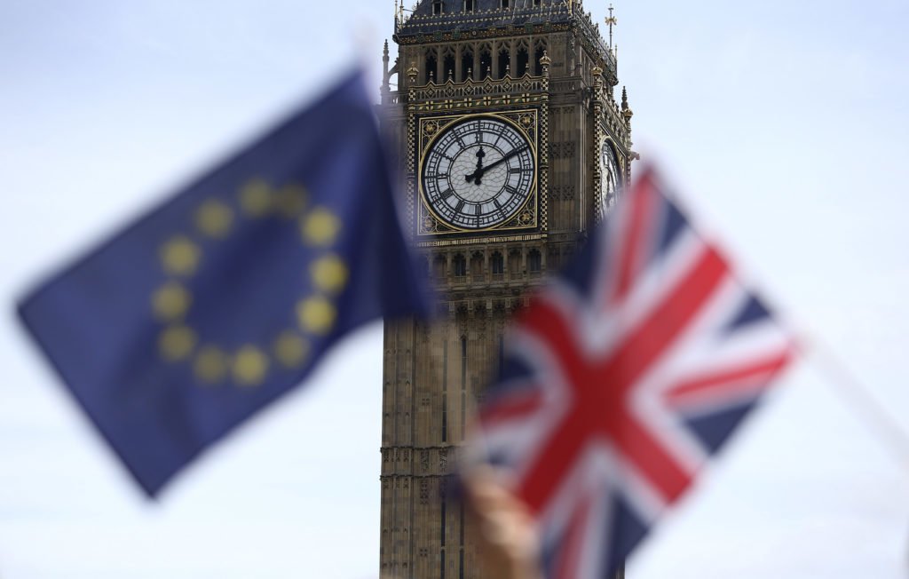 Participants hold a British Union flag and an EU flag during a pro-EU referendum event at Parliament Square in London, Britain June 19, 2016. REUTERS/Neil Hall - RTX2H0ON