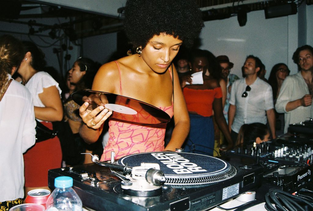 Zakia Sewell at a DJ deck during a party