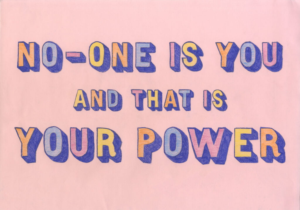 Pastel pink paper with hand-drawn lettering and coloured with pencil in this order: orange, light blue, light purple, yellow. They are shaded with dark blue. The letters read ‘No-one is you and that is your power’.