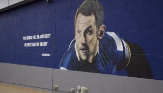 Rob Burrow mural on the side of a wall. The text reads "in a world full of adversity, we must dare to dream" - Rob Burrow