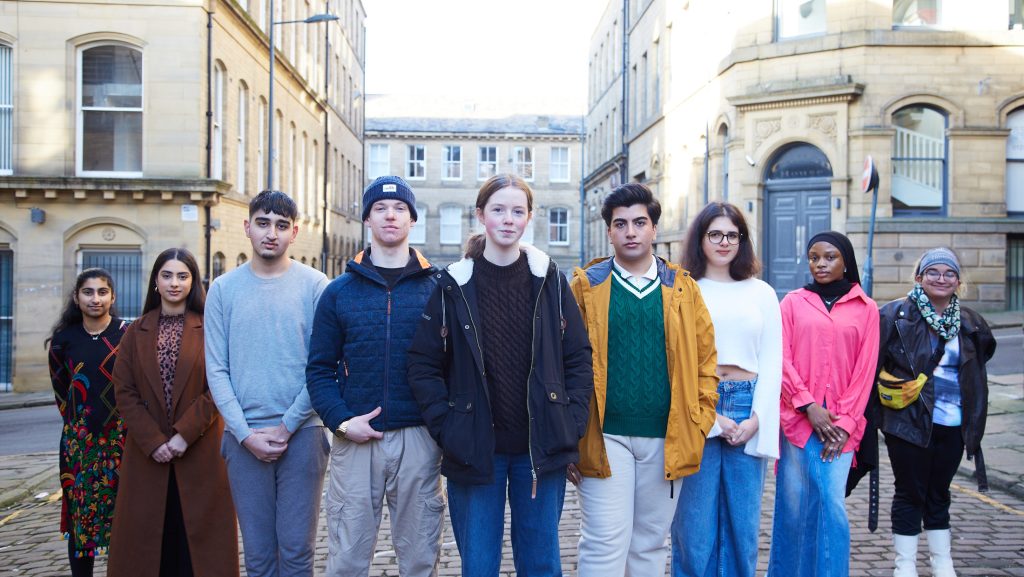 Photo of group of young people stood in a line on a street in Bradford. 