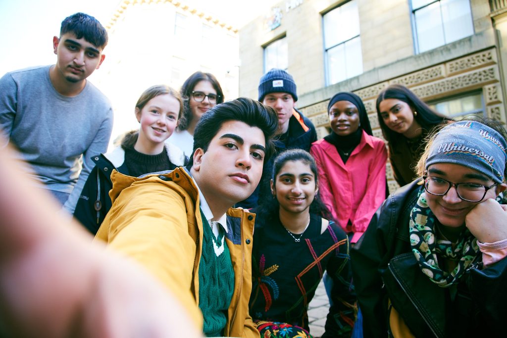 Photo of a group of young people stood outside looking into the camera. 