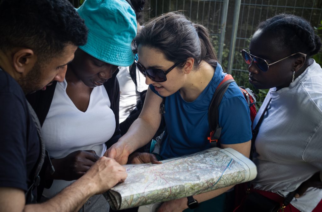 Picture of several people stood around reading a map