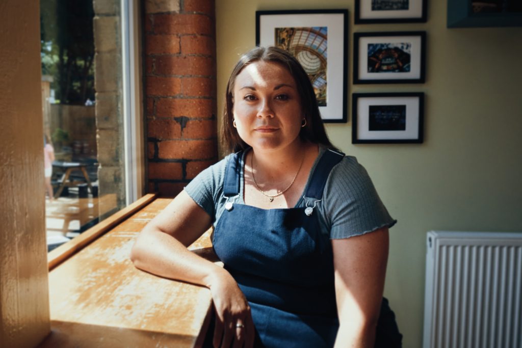 Image of maria Ferguson sat in a cafe.