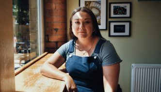 Image of maria Ferguson sat in a cafe.